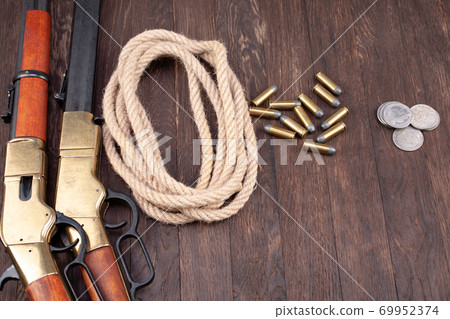 Wild west gun - lever-action repeating rifle with ammunition and silver dollar coins 69952374