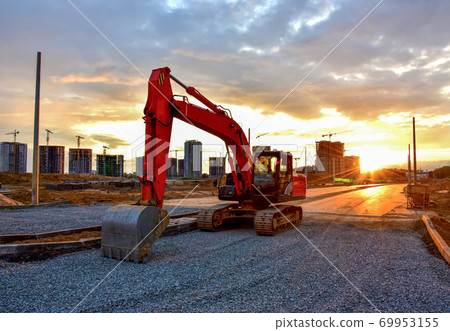 Excavator during road work at construction site Excavator during road work at construction site 69953155