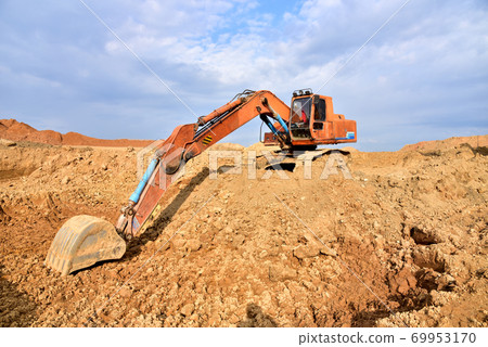 Excavator working on earthmoving at open pit 69953170