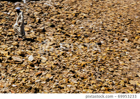 Moroccan man walking among stones in Casablanca Moroccan man walking among stones in Casablanca 69953233