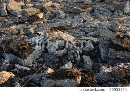 Broken pieces of asphalt at a construction site. Broken pieces of asphalt at a construction site. 69953234