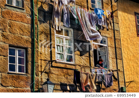 Woman at window hanging clothes in Lisbon Woman at window hanging clothes in Lisbon 69953449