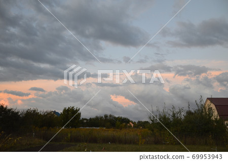 Colorful rain clouds at sunset 69953943