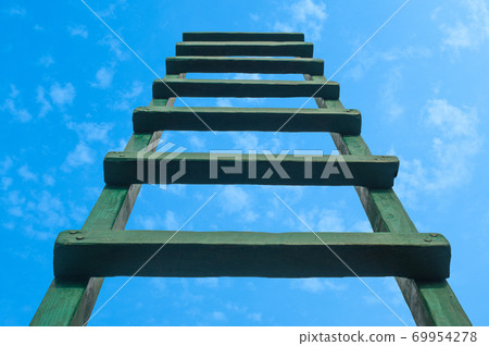 Reaching For Green Ladder Leading To A Blue Sky Reaching For Green Ladder Leading To A Blue Sky 69954278