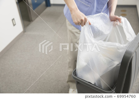 Cleaner collecting garbage Cleaner collecting garbage 69954760