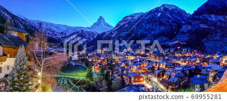 View of old village in twilight time with Matterhorn peak background in Zermatt, Switzerland. 69955281