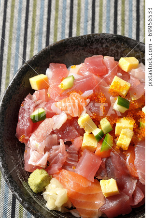 Seafood bowl with tuna and salmon placed on a Japanese-patterned cloth (overhead view) 69956533
