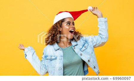 Fun surprised happy African American woman wearing Christmas Fun surprised happy African American woman wearing Christmas 69960097
