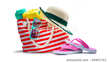 Striped red white beach bag with towel sunglasses flip-flops and hat isolated on white 69961781