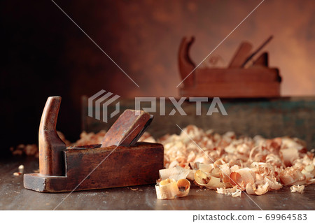 Old wooden jointers and shaving on wooden table. Old wooden jointers and shaving on wooden table. 69964583