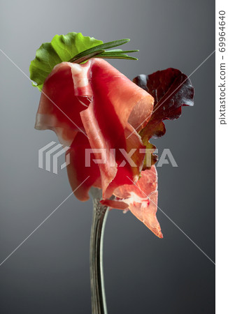 Prosciutto with rosemary. Prosciutto with rosemary. 69964640