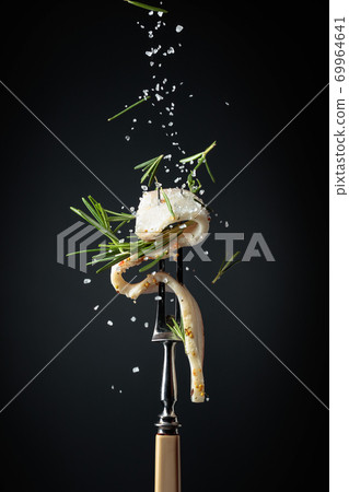 Slice of spicy lard sprinkled with salt and rosemary. Slice of spicy lard sprinkled with salt and rosemary. 69964641