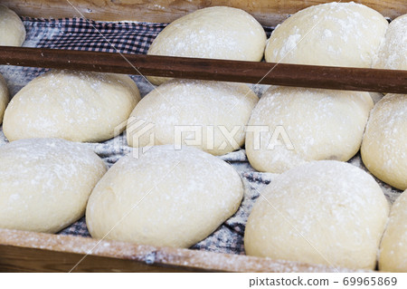 bread dough balls fermenting and waiting to put in the oven 69965869