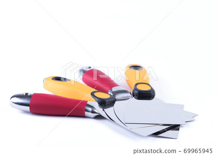 Professional putty knifes lying on white background Professional putty knifes lying on white background 69965945