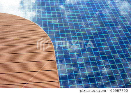 Swimming pool with wooden deck floor Swimming pool with wooden deck floor 69967790