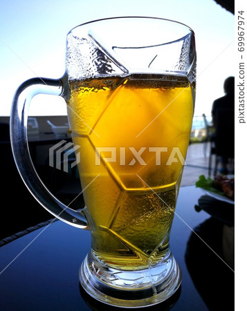 bubbles in the beer in the glass. the beer is poured into a beer glass and it flows in foam in a glass bubbles in the beer in the glass. the beer is poured into a beer glass and it flows in foam in a glass 69967974