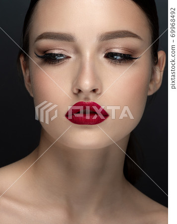 Portrait of young beautiful woman with red lips Portrait of young beautiful woman with red lips 69968492