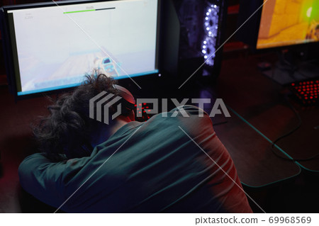 Exhausted programmer at workplace 69968569