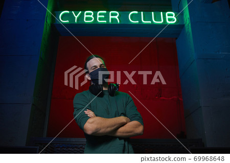 Gamer in mask at computer club Gamer in mask at computer club 69968648