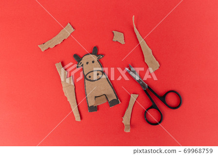 craft cow made of cardboard, craft for small children for a holiday, activity with parents, Paper art character bull cow craft for kids, Animal cardboard figurine, Children play home. Ox year. 69968759