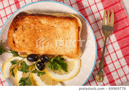 Good food for breakfast. Toast with butter and cheese. 69969776