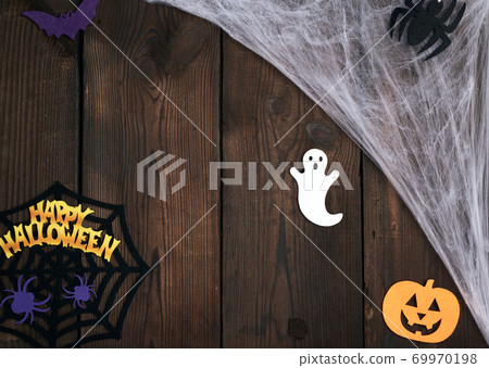 white spider web in the corner of the composition, gray wooden background from old boards 69970198