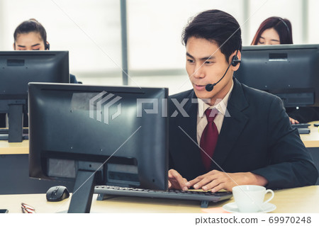 Business people wearing headset working in office 69970248