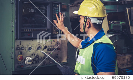 Smart factory worker using machine in factory workshop Smart factory worker using machine in factory workshop 69970380