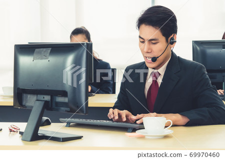 Business people wearing headset working in office 69970460