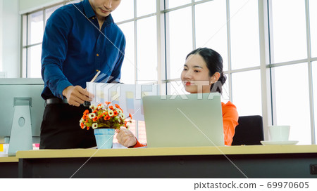 Two business people talk project strategy at office 69970605