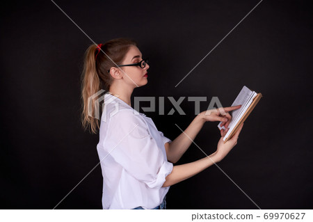 Beautiful american student girl is reading. 69970627