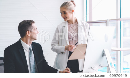 Two business people talk project strategy at office Two business people talk project strategy at office 69970649