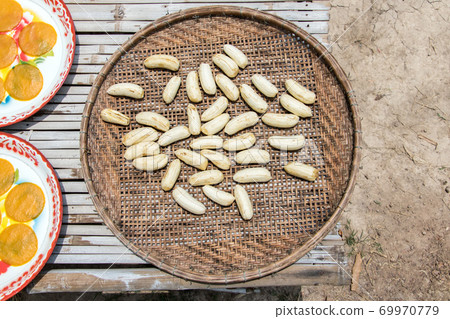 A bananas with slice of manga drying on the sun. A processing at village farm, Thailand 69970779