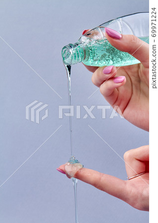 Girl's pouring green liquid soap. Girl's pouring green liquid soap. 69971224