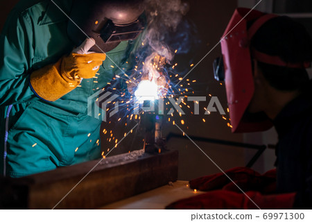 Metal welding steel works using electric arc welding machine Metal welding steel works using electric arc welding machine 69971300