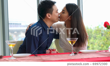 Happy romantic couple eating lunch at restaurant 69972300