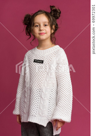 Photo of smiling little girl child isolated over pink background. 69972301