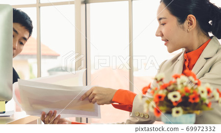 Two business people talk project strategy at office Two business people talk project strategy at office 69972332