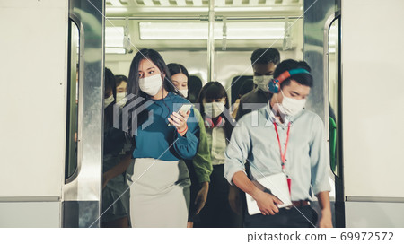 Crowd of people wearing face mask on a crowded public subway train travel 69972572