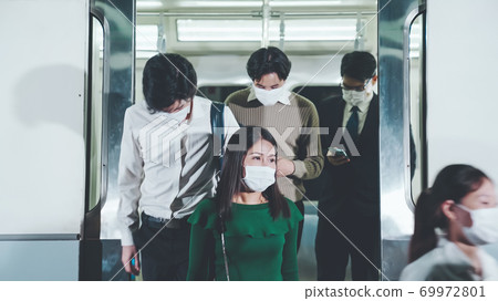 Crowd of people wearing face mask on a crowded public subway train travel 69972801