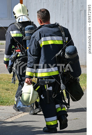 Firefighter at the scene of a fire 69972995