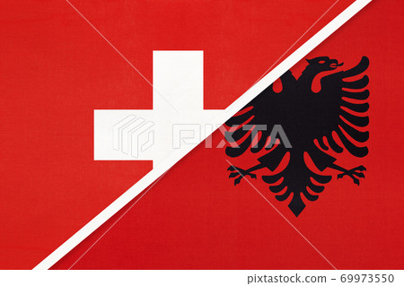 Switzerland and Albania, symbol of national flags from textile. Championship between two countries. 69973550