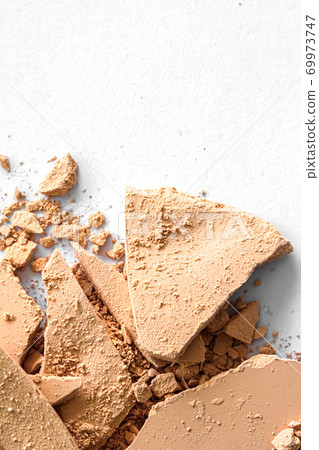 Beige eye shadow powder as makeup palette closeup isolated on white background, crushed cosmetics and beauty texture 69973747