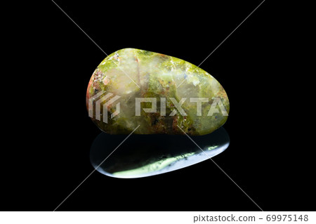 Green and pink natural rock Unakit with reflection isolated on black background 69975148