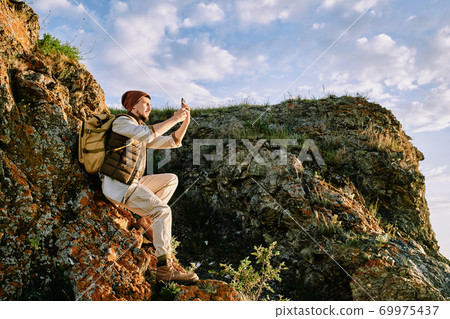 Photographing landscape on smartphone 69975437