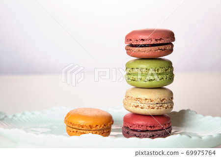 Fashionable macaroons with berries and pistachios Fashionable macaroons with berries and pistachios 69975764