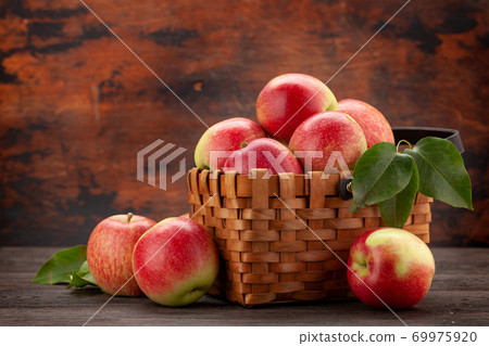 Ripe garden apple fruits in basket 69975920
