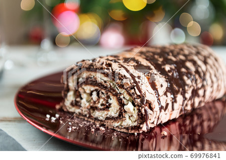 Belgian Chocolate Meringue Roulade filled with whipped cream and Belgian Chocolate Meringue Roulade filled with whipped cream and 69976841