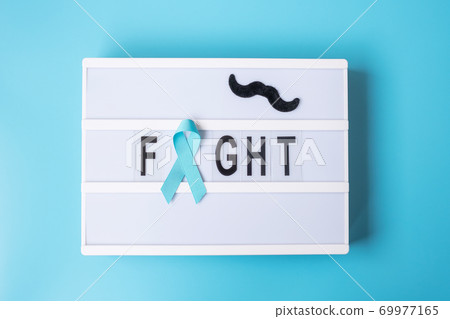 Prostate Cancer Awareness month, Light blue Ribbon with mustache on lightbox with fight text background for supporting people living and illness. International Men day and World cancer day concept 69977165