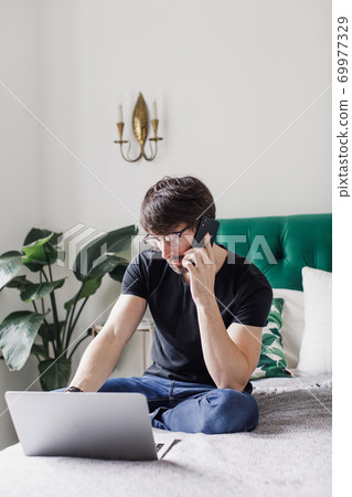 a man orders food on the phone. food delivery a man orders food on the phone. food delivery 69977329